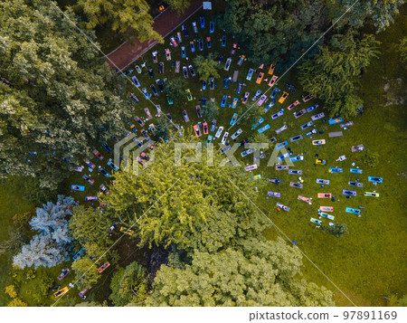 overhead view of people do yoga at city public park overhead view of people do yoga at city public park 97891169
