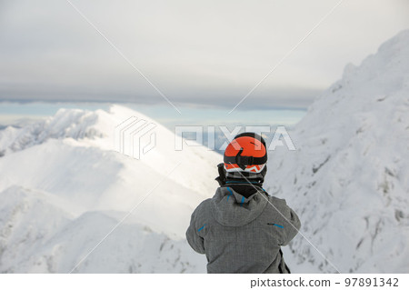 man skier enjoying landscape view of winter mountains 97891342