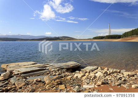 The Barcena reservoir with the chimneys of Compostilla thermal power station at background in Cubillos del Sil, el Bierzo, Castile and Leon, Spain. The Barcena reservoir with the chimneys of Compostilla thermal power station at background in Cubillos del Sil, el Bierzo, Castile and Leon, Spain. 97891358