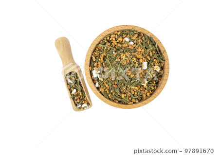 Green tea Japanese Genmaicha. Green tea mixed with roasted popped brown rice in wooden bowl and scoop isolated on white background. 97891670