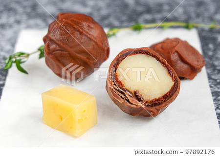 Chocolate-covered cheese, chocolate balls stuffed with cheese. Trendy dessert.  97892176