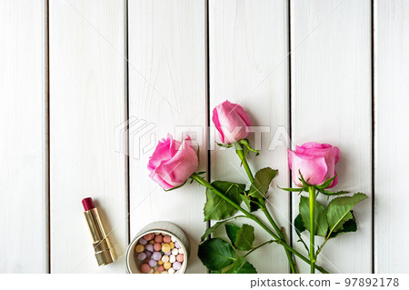 Top view arrangement with make-up, roses and copy-space on white wooden background 97892178