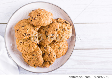 Homemade oatmeal raisin cookies on a plate. Healthy baking. Top view. Copy space Homemade oatmeal raisin cookies on a plate. Healthy baking. Top view. Copy space 97892260