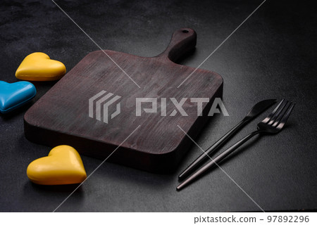 Chocolate hearts in the colors of the Ukrainian flag on a black ceramic plate Chocolate hearts in the colors of the Ukrainian flag on a black ceramic plate 97892296