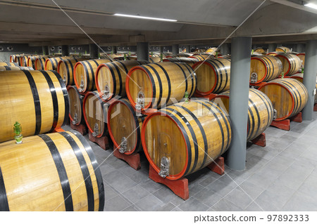 wine cellar full of wooden barrels in Barolo, Piedmont, Italy 97892333