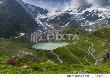 Typical alpine landscape of Swiss Alps with Steinsee, Urner Alps, Canton of Bern, Switzerland Typical alpine landscape of Swiss Alps with Steinsee, Urner Alps, Canton of Bern, Switzerland 97892465