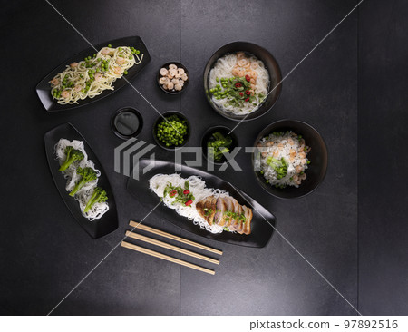 Various dishes of Asian cuisine with different types noodles and rice with shrimp, duck, vegetables and black sesame Various dishes of Asian cuisine with different types noodles and rice with shrimp, duck, vegetables and black sesame 97892516