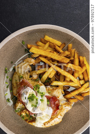 typical czech cuisine chicken slice baked with ham and camembert with french fries 97892517