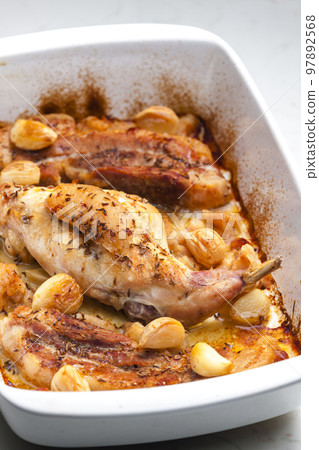 baked rabbit leg with garlic and bacon baked rabbit leg with garlic and bacon 97892568