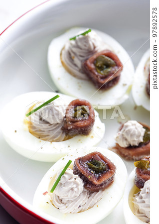 eggs filled with anchoa spread with anchoa on the top eggs filled with anchoa spread with anchoa on the top 97892578