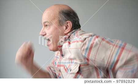 running senior man isolated on gray background 97892829