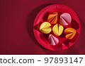 paper fortune cookies on red paper plate, korean or chinese style creative background, happy lunar new year 97893147