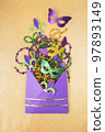 Multi color Mardi Gras background with beads and envelop. Top view 97893149