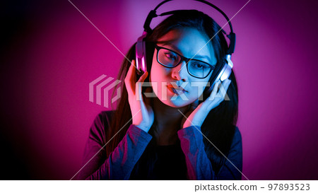 Young Asian woman dreams while listening to music 97893523