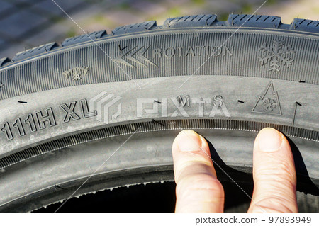 Markings on the sidewall of a new winter tire, speed, load, rotation, mud and snow designations 97893949
