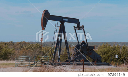 Oil pump in the countryside of Oklahoma - Pump jack 97894149