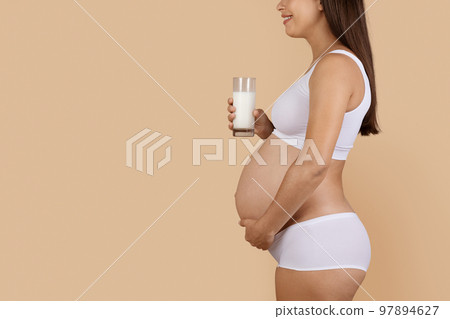 Dairy Foods In Pregnancy. Pregnant Woman Holding Glass Of Milk 97894627