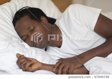Closeup Shot Of Young African American Guy Sleeping In Bed At Home 97894746