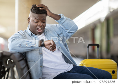 Late For Train. Stressed Black Guy At Railway Station Looking At Wristwatch Late For Train. Stressed Black Guy At Railway Station Looking At Wristwatch 97894826