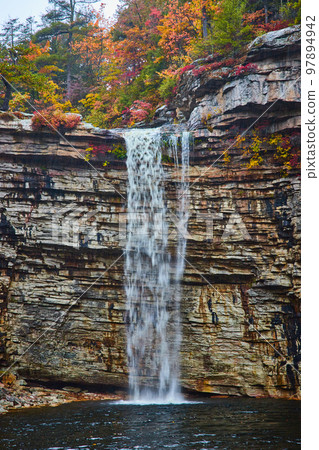 Detail of large waterfall over cliff edge into body of water Detail of large waterfall over cliff edge into body of water 97894942