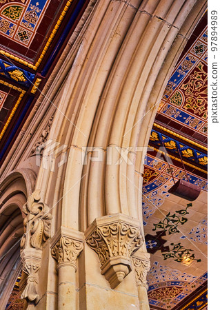 Detail of limestone arches with murals on ceiling in Central Park New York City 97894989