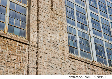 Detail of stone wall and industrial building windows 97895039