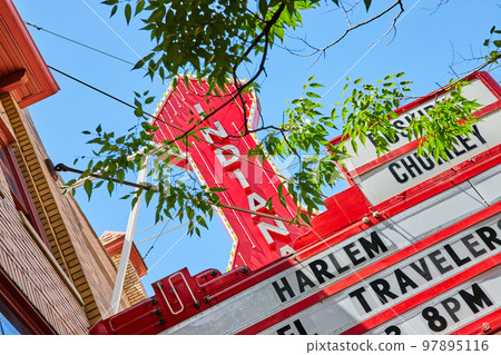 Detail of red Indiana sign through trees for theater in Bloomington Detail of red Indiana sign through trees for theater in Bloomington 97895116