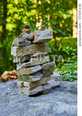 Cairn stack of rectangular rocks in forest Cairn stack of rectangular rocks in forest 97895136