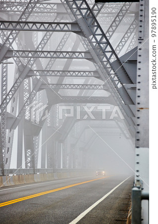 Cars going down extremely foggy steel bridge from side Cars going down extremely foggy steel bridge from side 97895190