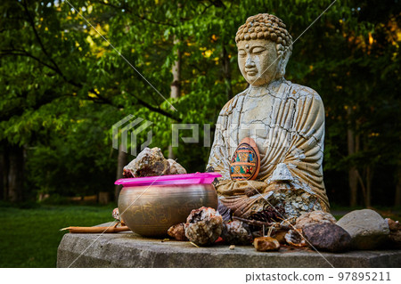 Buddhist prayer small statue with cracks and donations around 97895211