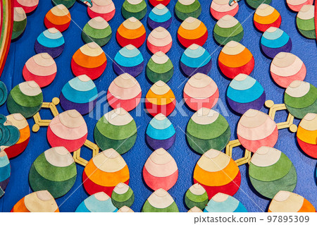 Colorful drop pattern on Tibetan Mongolian Buddhist shrine wall 97895309