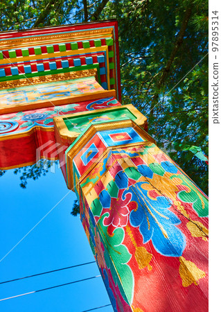 Colorful main gate post details at Tibetan Mongolian Buddhist Cultural Center 97895314
