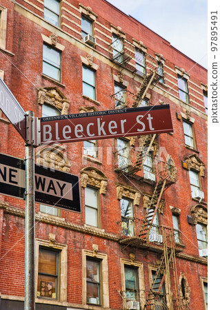 Bleecker Street sign in Greenwich Village New York City with brick building behind Bleecker Street sign in Greenwich Village New York City with brick building behind 97895491