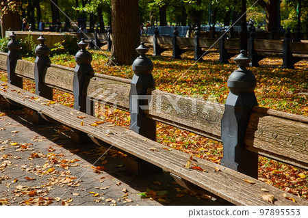 Benches of iconic The Mall Central Park in New York City during fall 97895553