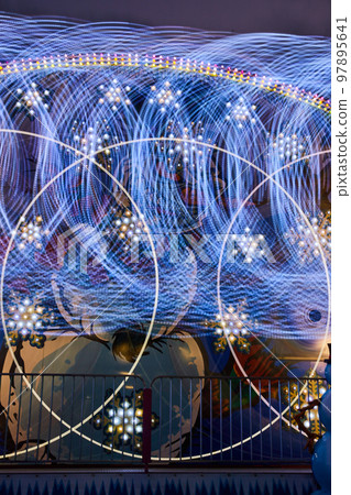 Abstract winter wonderland carnival ride detail of lights blurred forming circles and snowflakes 97895641