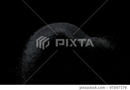 Million of black sand explosion, Photo image of falling down sands flying. Freeze shot on black background isolated overlay. Tiny Fine sand dust magnet as particle disintegrate science 97897376