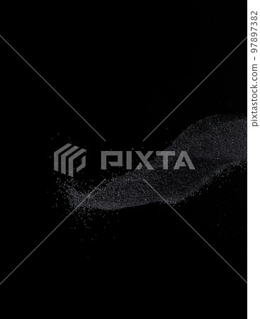 Million of black sand explosion, Photo image of falling down sands flying. Freeze shot on black background isolated overlay. Tiny Fine sand dust magnet as particle disintegrate science 97897382