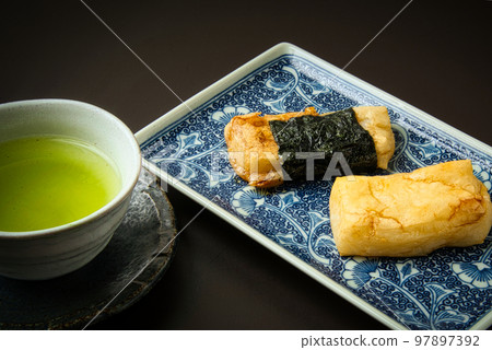 Isobe-yaki is made by grilling home-made rice cakes, dipping them in soy sauce and wrapping them in seaweed. Isobe-yaki is made by grilling home-made rice cakes, dipping them in soy sauce and wrapping them in seaweed. 97897392