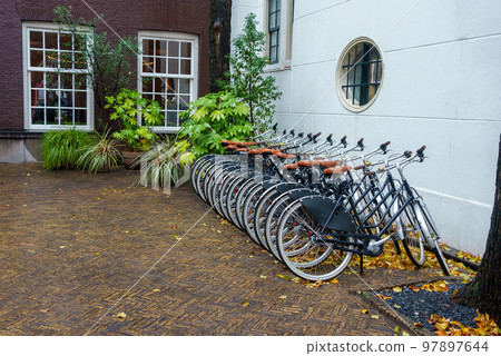 Plenty bicycles at parking lot in Amsterdam Plenty bicycles at parking lot in Amsterdam 97897644