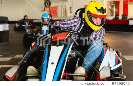 Portrait of lucky man driving racing car Portrait of lucky man driving racing car 97898043