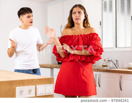 Young husband is dissatisfied with the act of his wife Young husband is dissatisfied with the act of his wife 97898261
