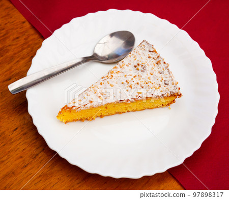 Slice of Spanish almond pie Torta de Santiago 97898317