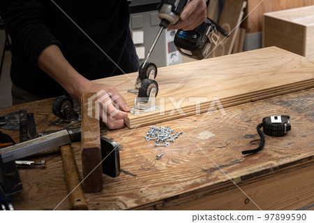 Furniture maker working in the workshop 97899590