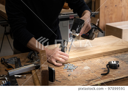 Furniture maker working in the workshop 97899591