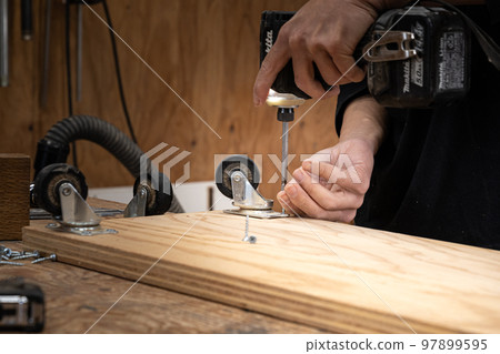 Furniture maker working in the workshop Furniture maker working in the workshop 97899595