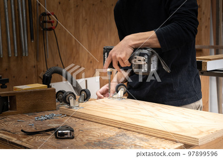 Furniture maker working in the workshop 97899596