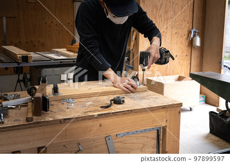 Furniture maker working in the workshop Furniture maker working in the workshop 97899597