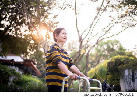 Senior woman hand holding walker try to walking at outdoor,Physical therapy concept Senior woman hand holding walker try to walking at outdoor,Physical therapy concept 97900191