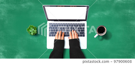 Person using a laptop computer Person using a laptop computer 97900608