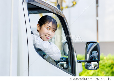 Female driver driving a truck Female driver driving a truck 97902219